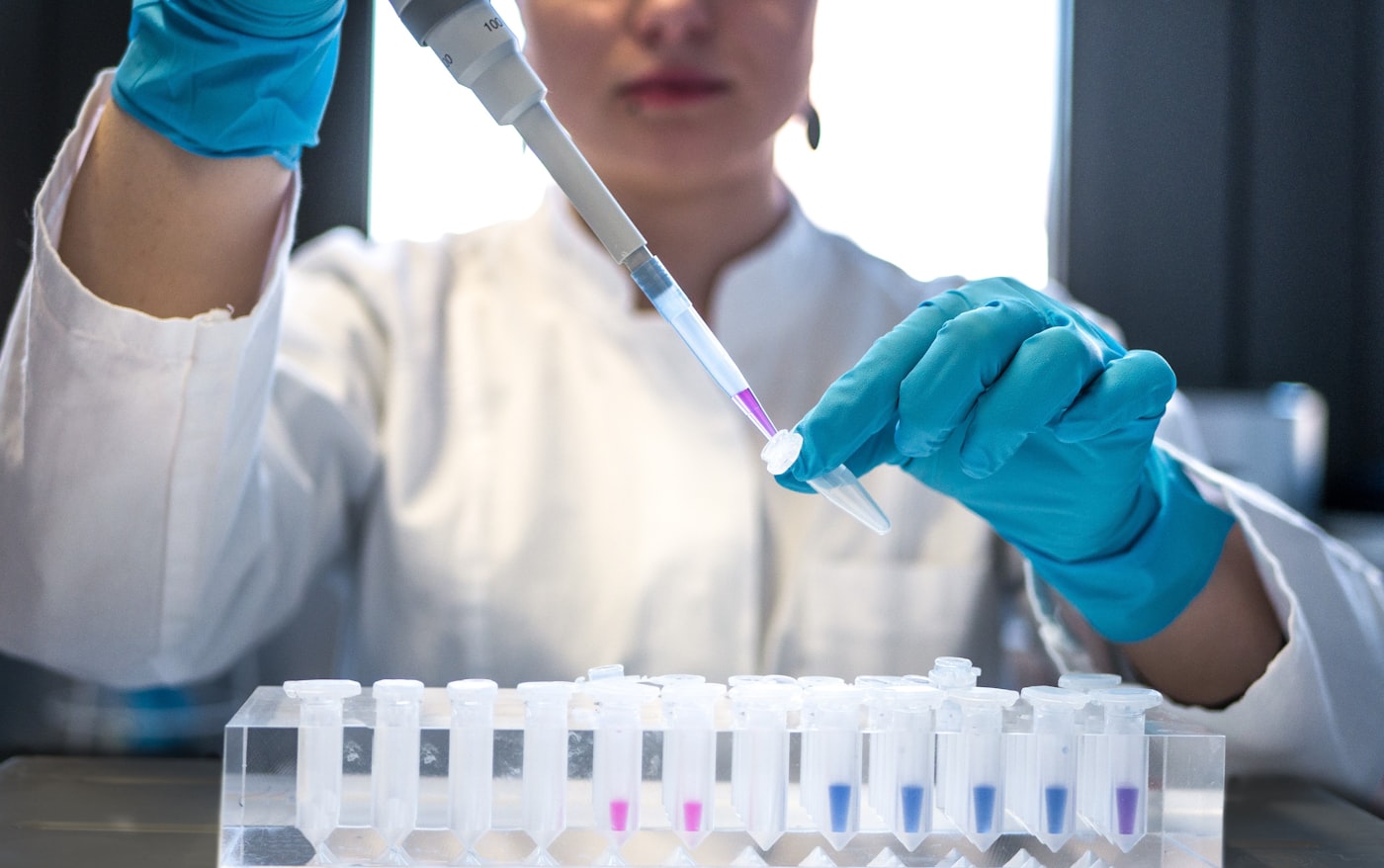 Scientist preparing samples with a pipette in a modern laboratory